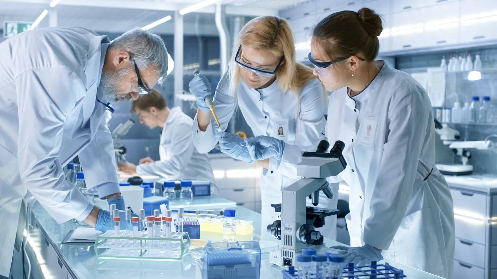 Scientists in lab wearing protective glasses