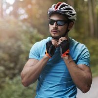 Man wearing sports eyewear while riding a bike