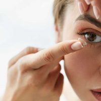woman putting in contacts