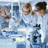 Scientists in lab wearing protective glasses